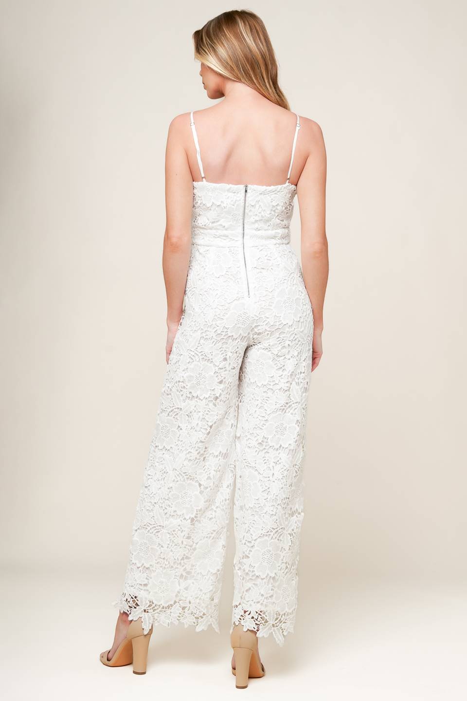 A woven lace jumpsuit featuring straight neckline, cami straps, wide leg and back zipper closure.