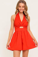 A solid red woven romper featuring halter neckline, front cut out and smocked back bodice