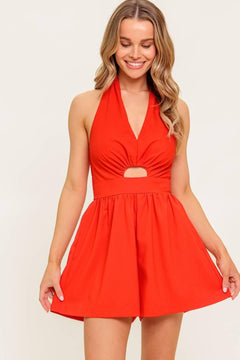 A solid red woven romper featuring halter neckline, front cut out and smocked back bodice