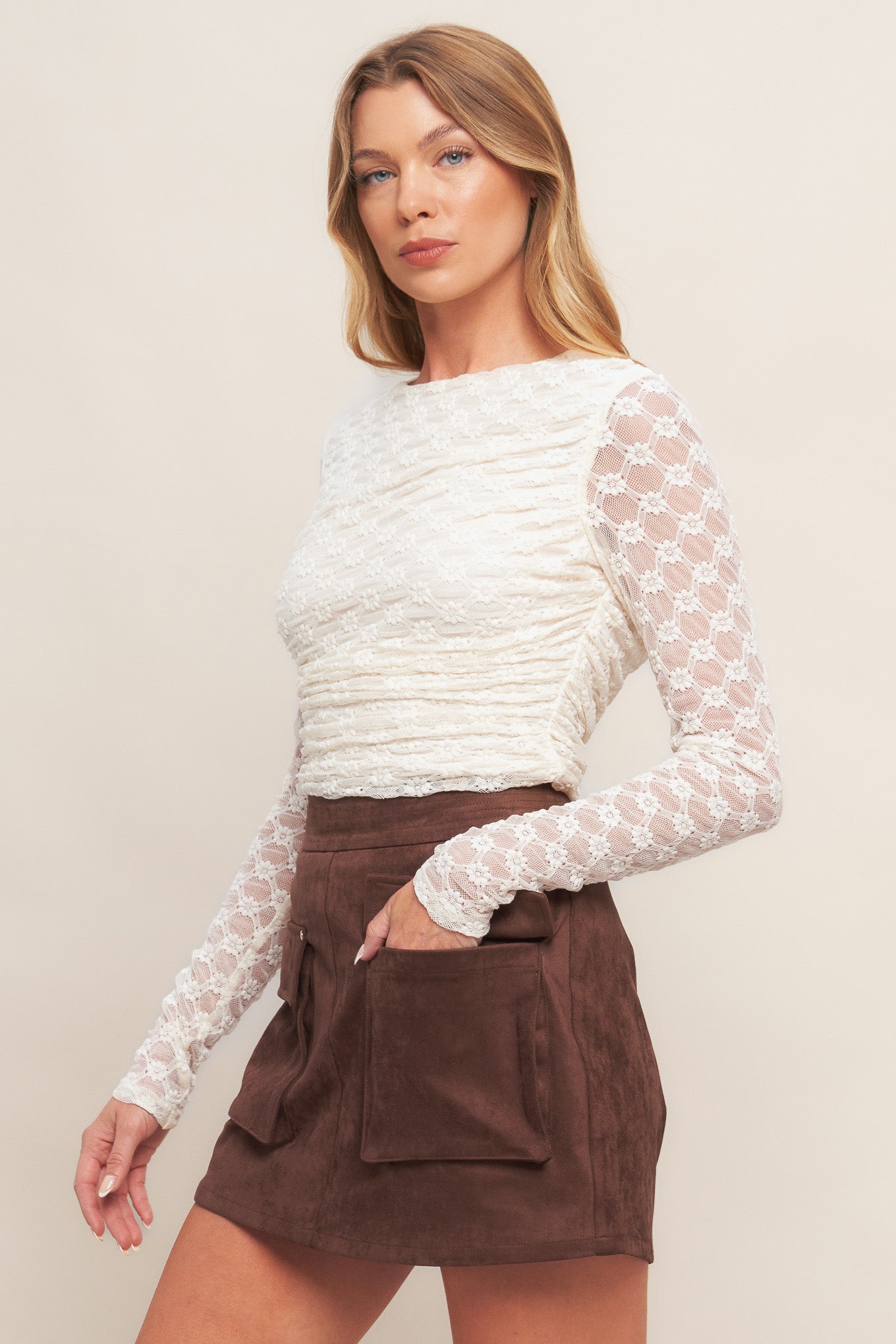 A faux suede skort featuring front pockets and back zipper closure