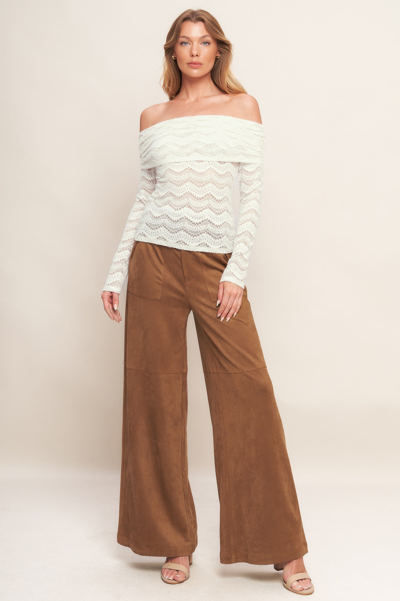 A faux suede pant featuring front closure, side pocket with braided detail and wide leg.