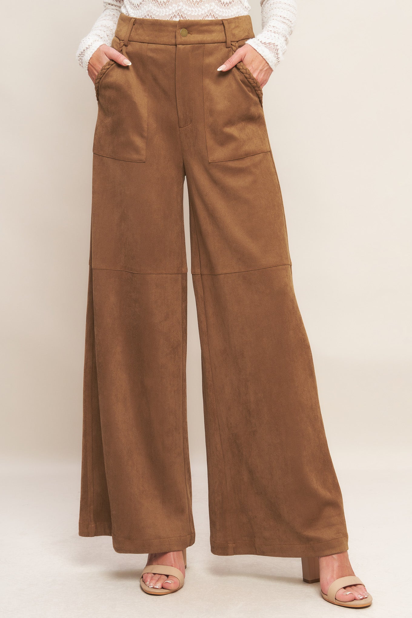 A faux suede pant featuring front closure, side pocket with braided detail and wide leg.