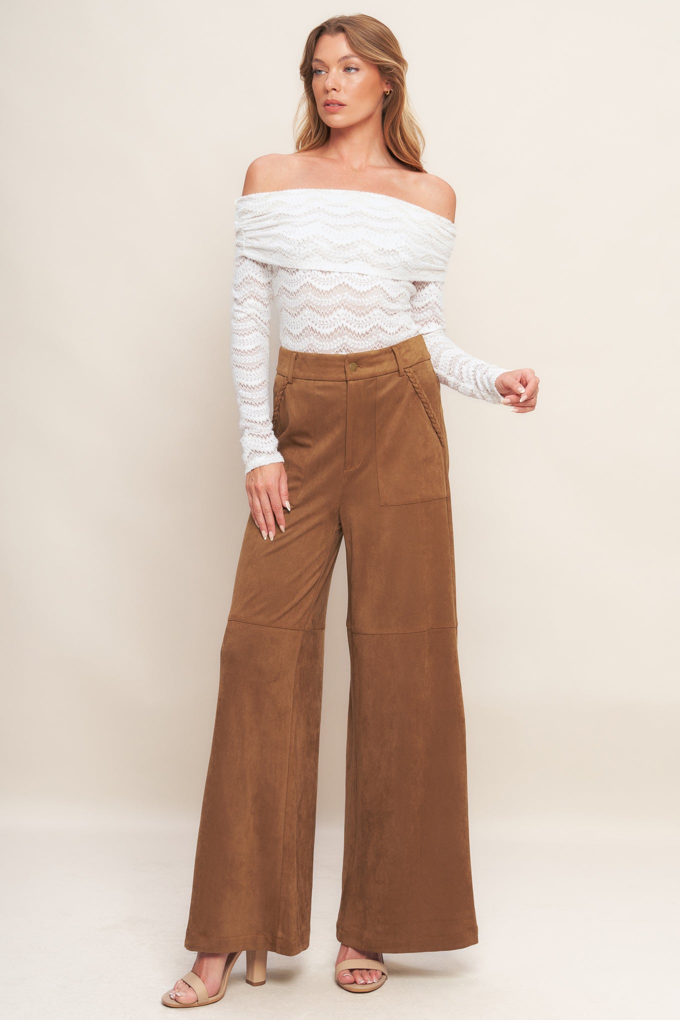 A faux suede pant featuring front closure, side pocket with braided detail and wide leg.