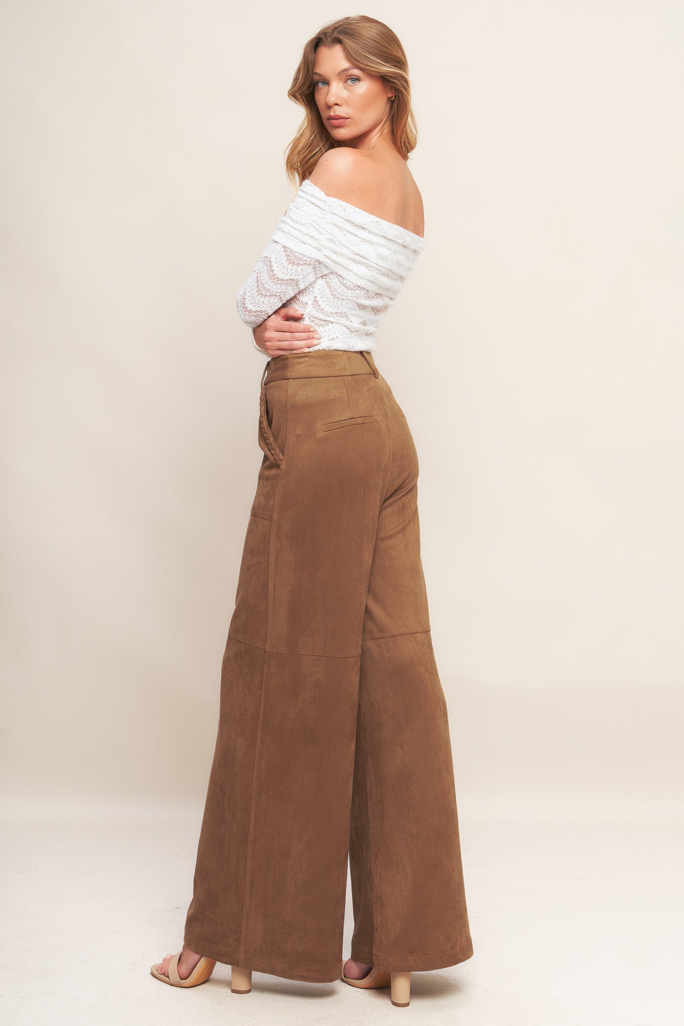 A faux suede pant featuring front closure, side pocket with braided detail and wide leg.