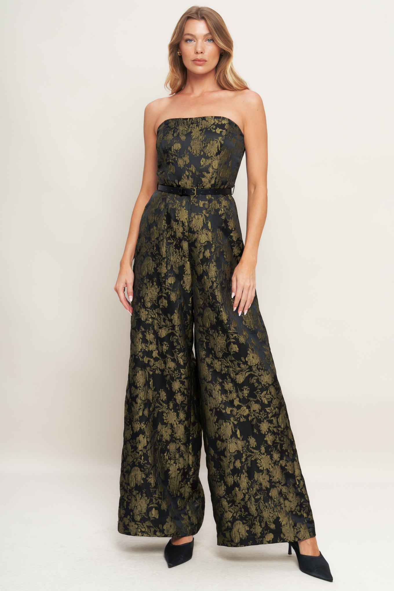 A jacquard woven jumpsuit featuring strapless neckline, contrasting belt, wide leg and back zipper closure