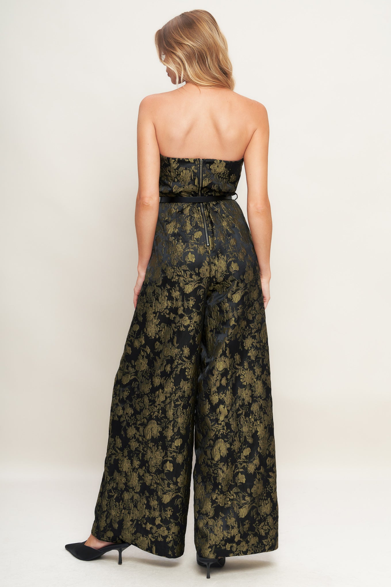 A jacquard woven jumpsuit featuring strapless neckline, contrasting belt, wide leg and back zipper closure