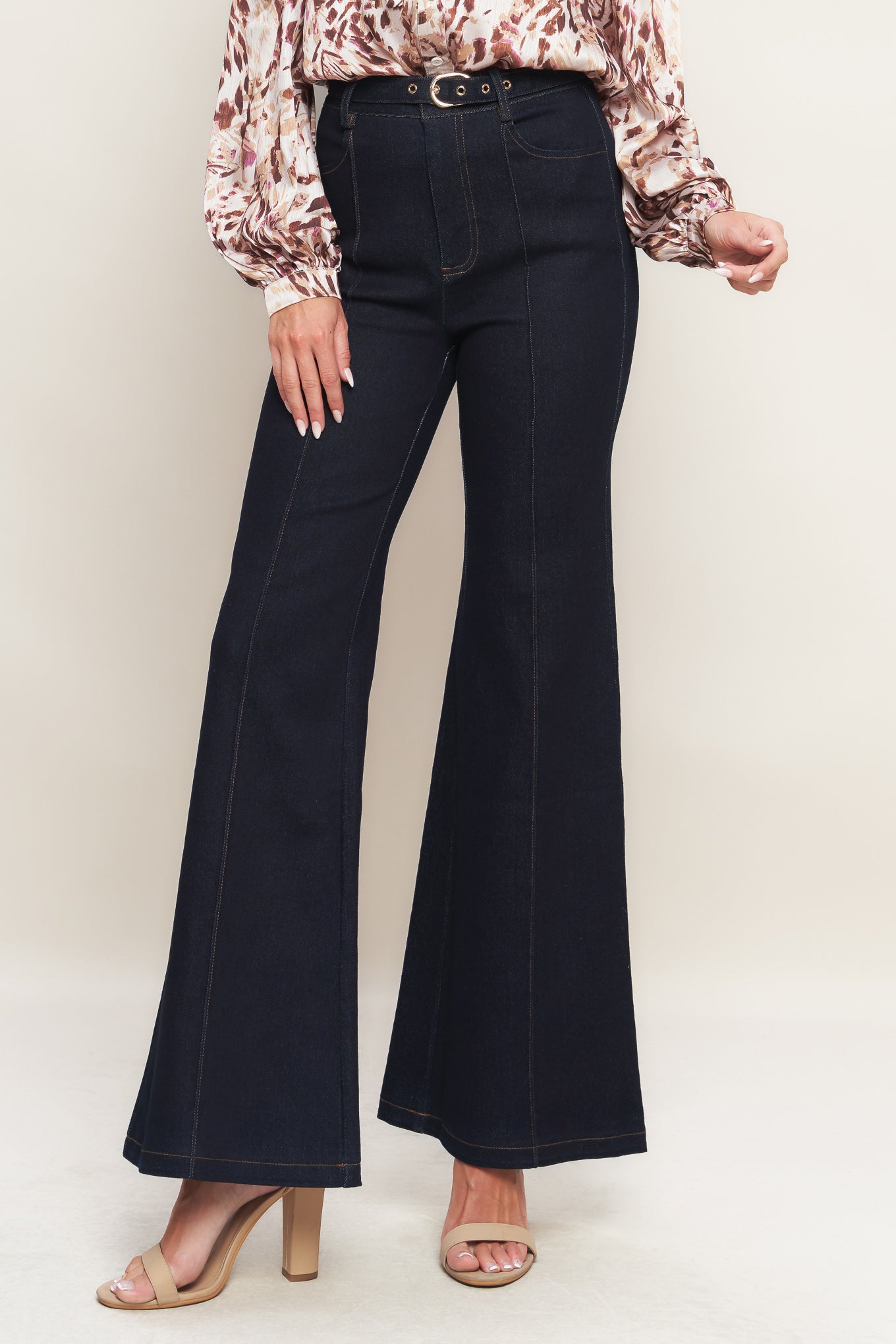 A denim pant featuring front closure, side pockets, self belt and flare leg
