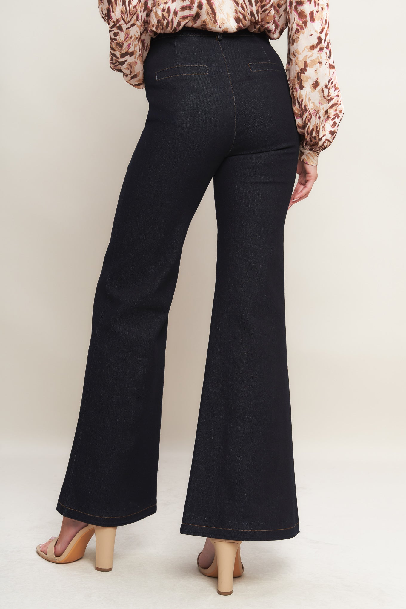 A denim pant featuring front closure, side pockets, self belt and flare leg