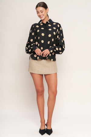 A tweed skort with faux front pocket flap and back zipper closure