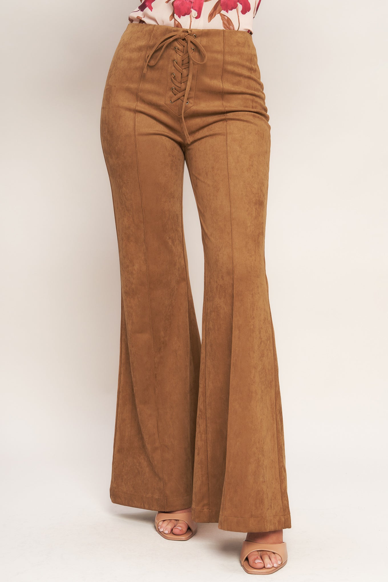A faux suede pant featuring front lace up detail, flare leg and back zipper closure