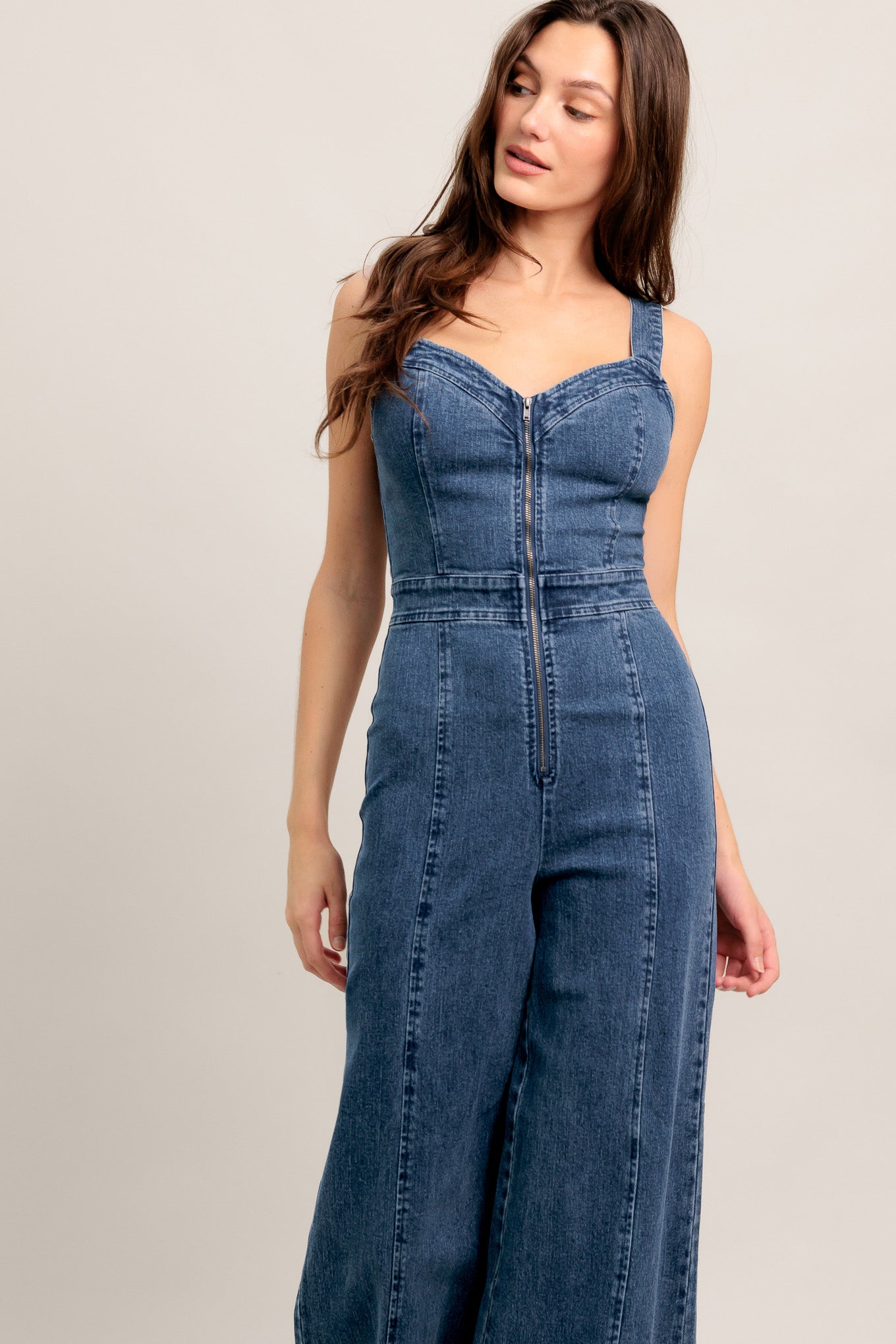 
A washed denim jumpsuit featuring V neckline, straps and front zipper closure

Details:

Self : 99% Cotton 1% Spandex

Size &amp; Fit

- Model is 5`8" And Wearing Size Small
- Measurements Taken From Size Small
- Approx. Length: 60" FLYING TOMATO