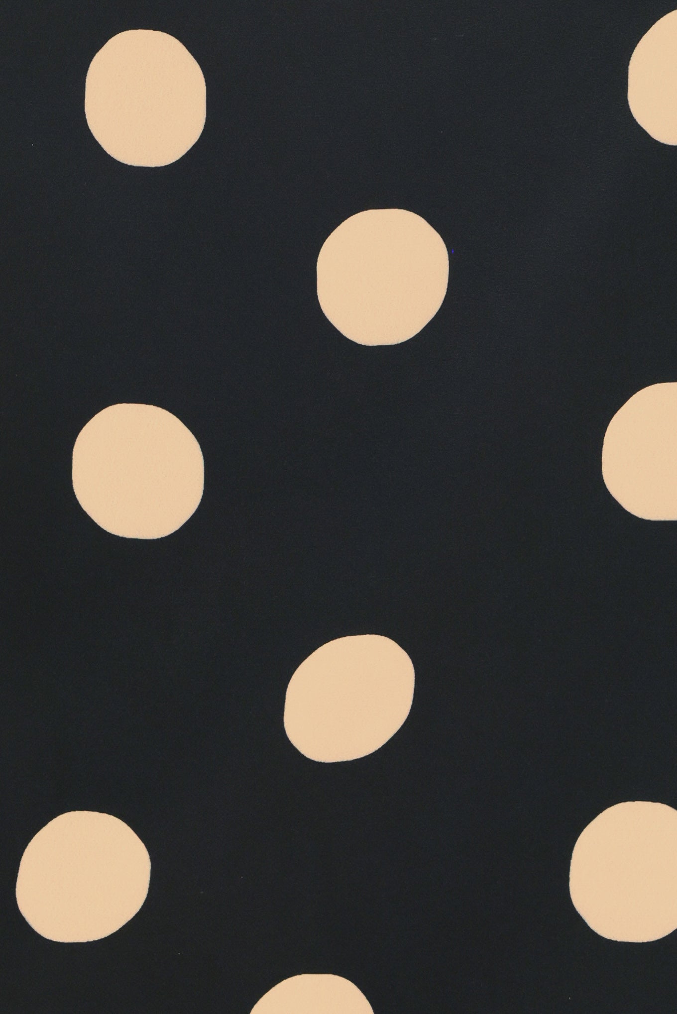 A woman wearing a black mini skort with large beige polka dots | Flying Tomato