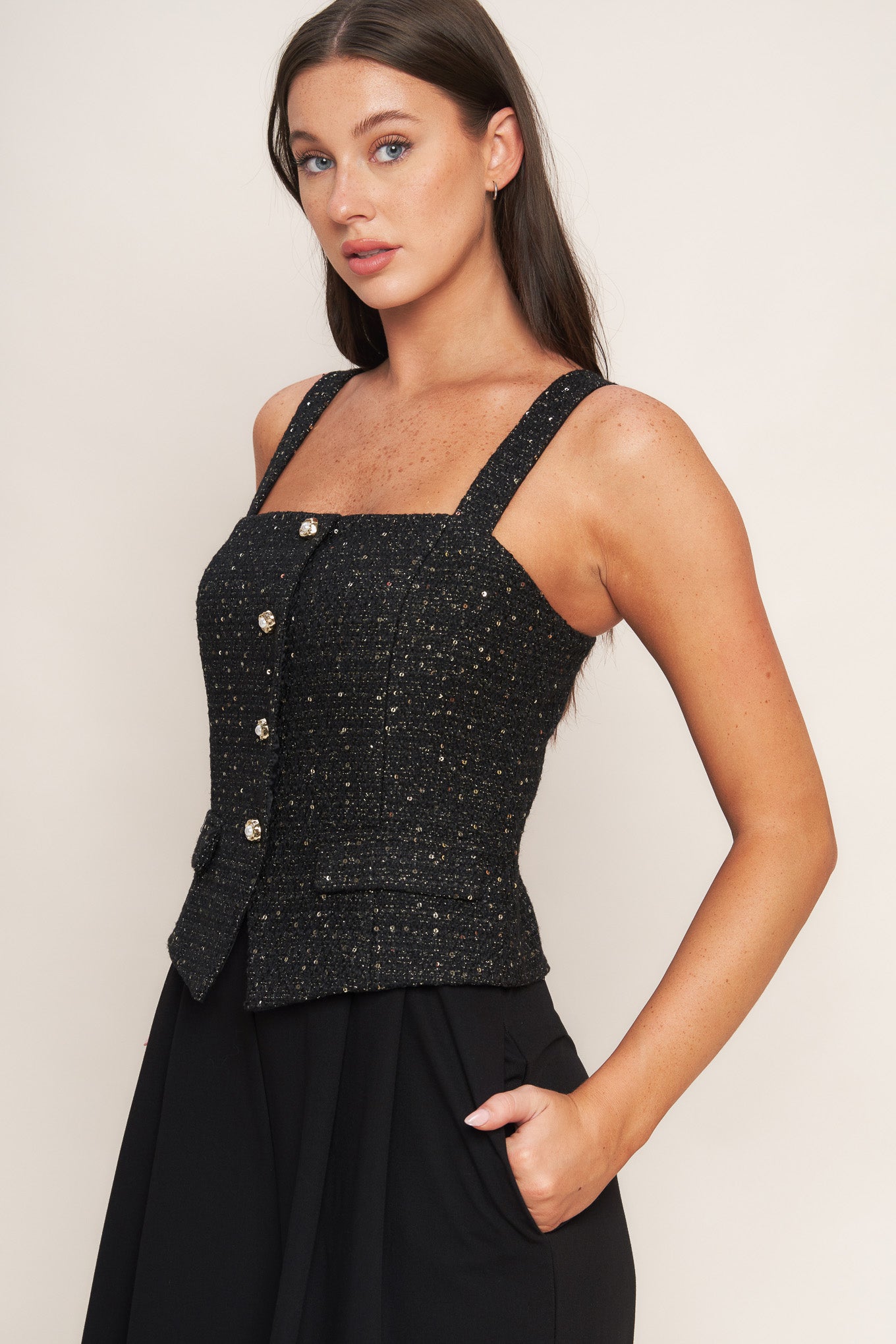 A woven jumpsuit featuring tweed bodice with straight neckline and strap, button down detail, solid woven wide leg pant and back zipper closure
