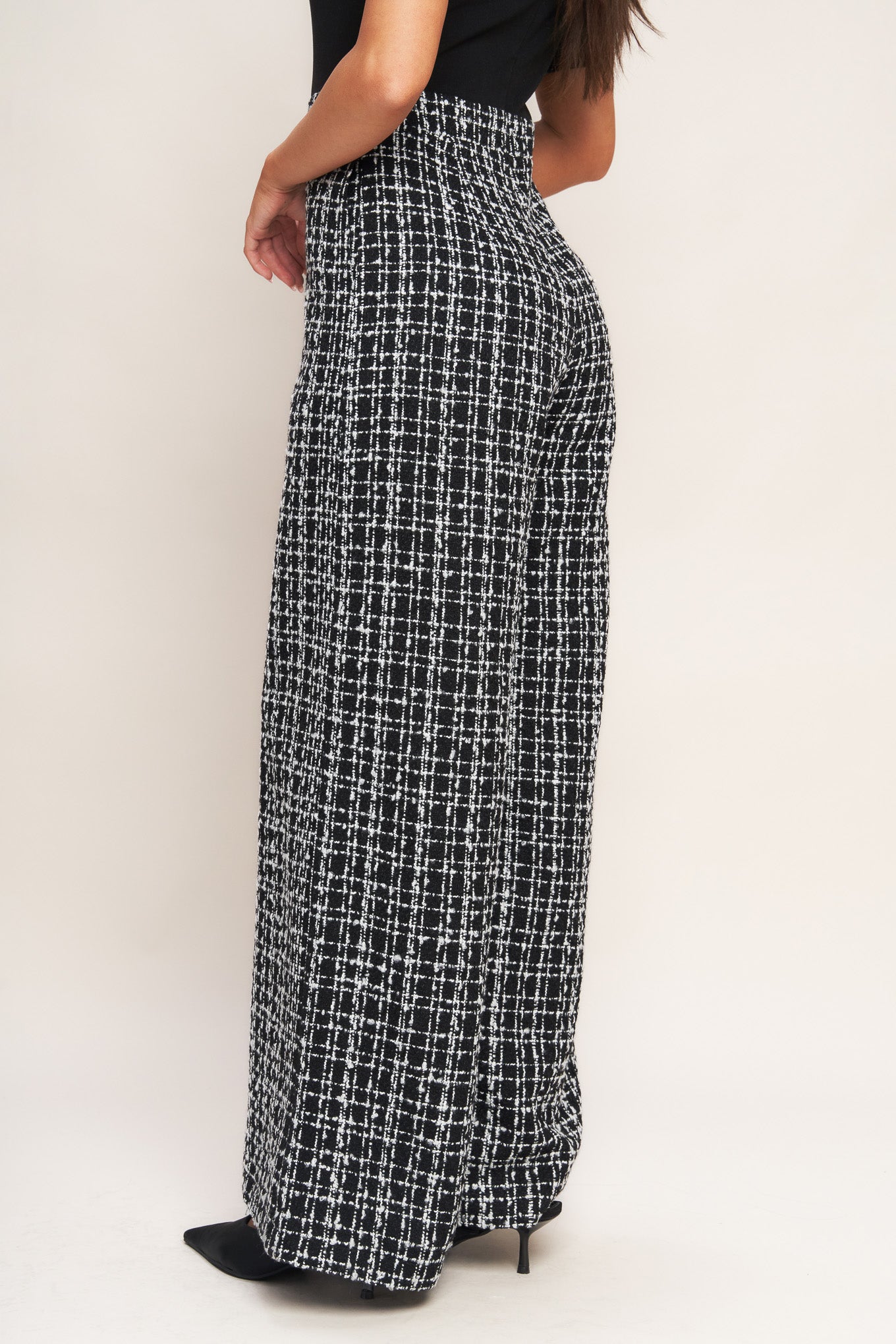 A ribbed knit top and tweed pant jumpsuit featuring mock neckline, short sleeve, side leg and back zipper closure