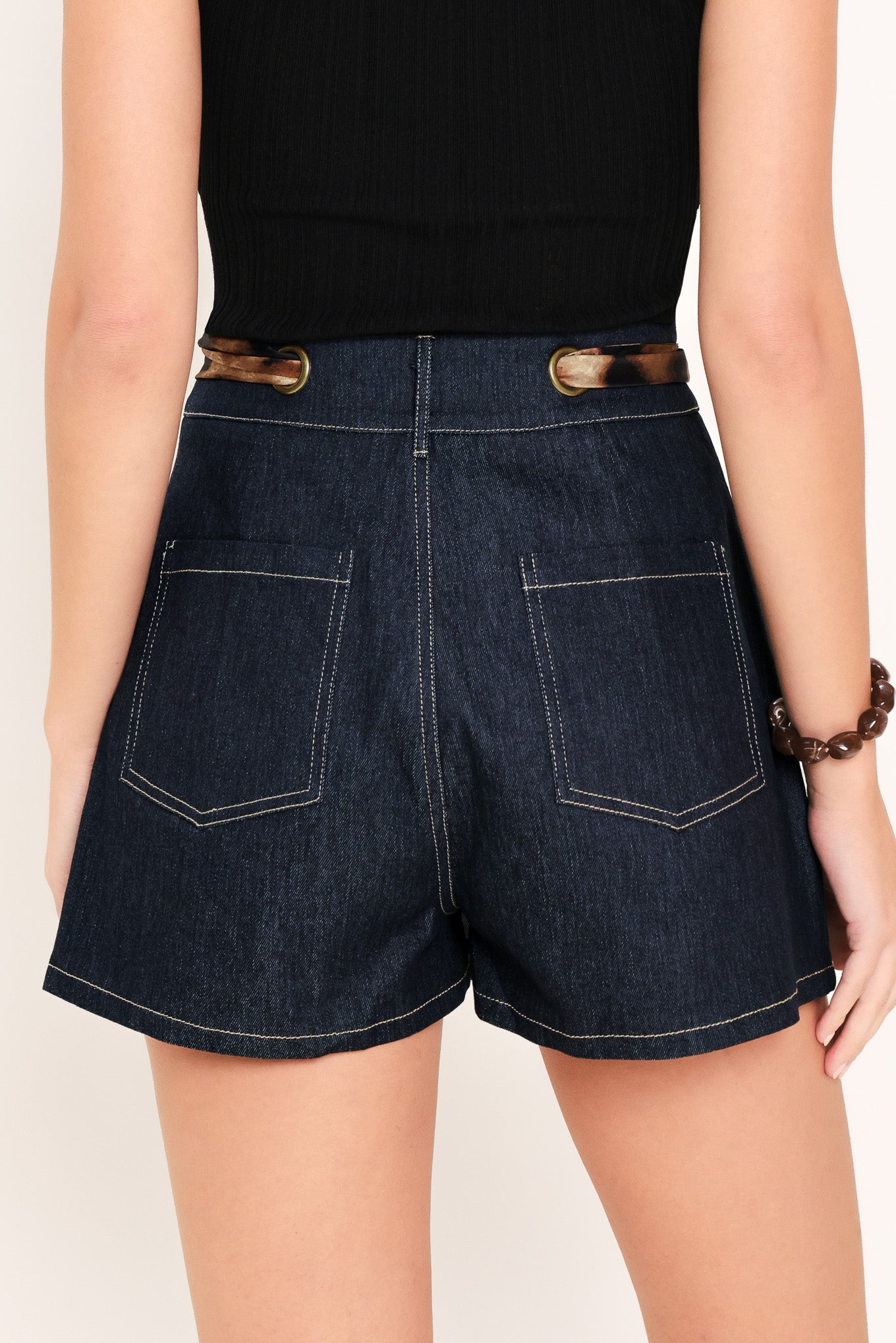 Woman wearing a denim skort with a leopard print ribbon waist tie | Flying Tomato