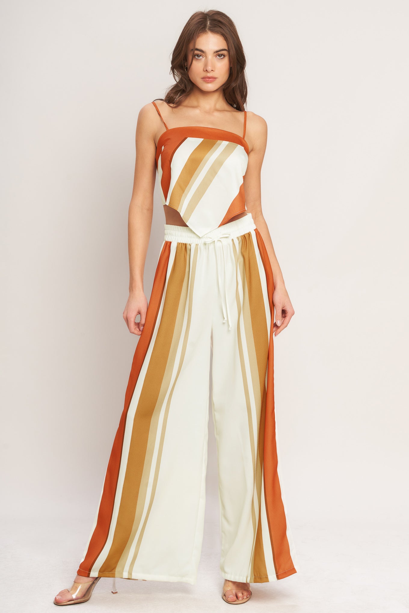 A printed woven pant featuring elastic waist with front tie and wide leg.