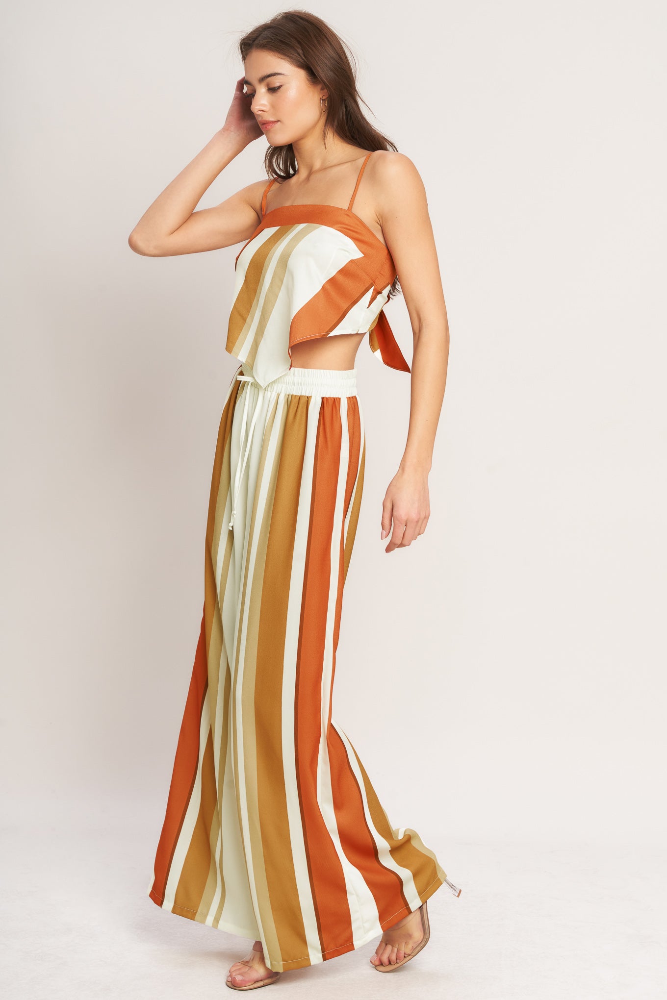 A printed woven pant featuring elastic waist with front tie and wide leg.