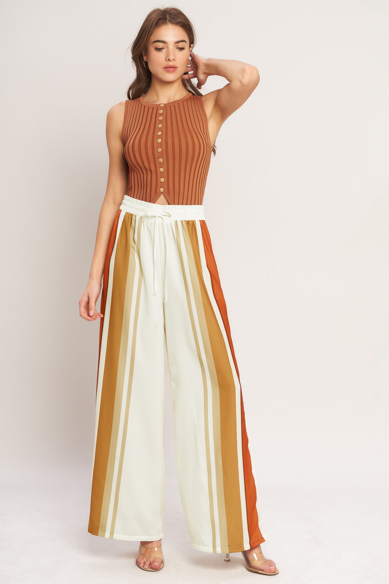 A printed woven pant featuring elastic waist with front tie and wide leg.