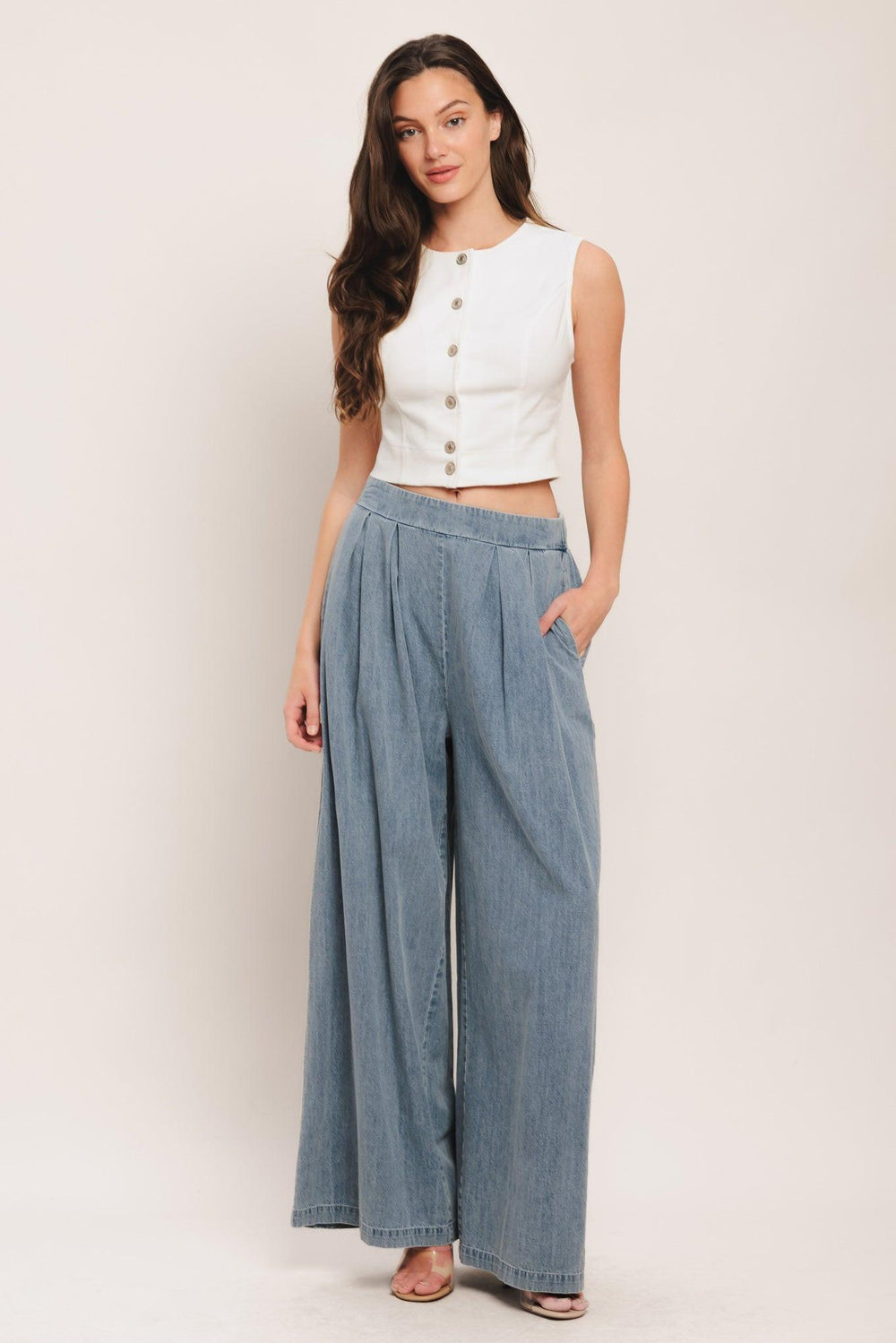 A lightweight washed denim pant with front pleats, wide leg and elasticized back waistband. Matching top IT14026B

Details:

Self: 100% Cotton

Contrast: 100% Cotton

Size & Fit

-Model is 5`8" And Wearing Size Small
-Measurements Taken From Size Small
-Approx. Length: 43"