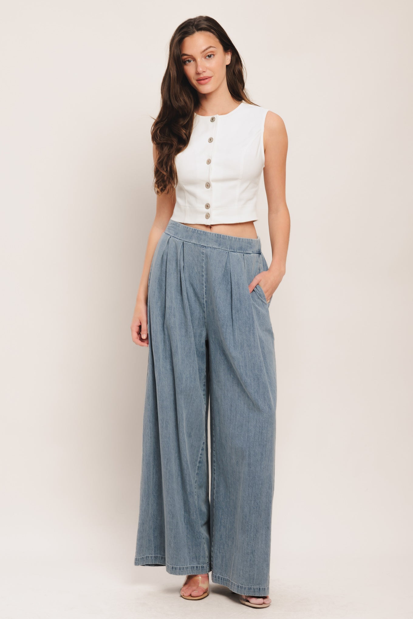 A lightweight washed denim pant with front pleats, wide leg and elasticized back waistband. Matching top IT14026B

Details:

Self: 100% Cotton

Contrast: 100% Cotton

Size & Fit

-Model is 5`8" And Wearing Size Small
-Measurements Taken From Size Small
-Approx. Length: 43"