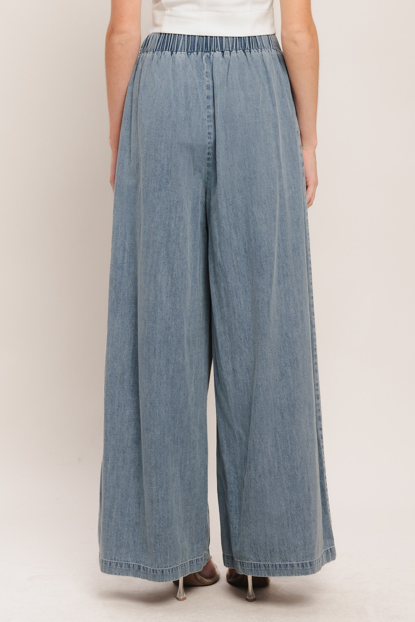 A lightweight washed denim pant with front pleats, wide leg and elasticized back waistband. Matching top IT14026B

Details:

Self: 100% Cotton

Contrast: 100% Cotton

Size & Fit

-Model is 5`8" And Wearing Size Small
-Measurements Taken From Size Small
-Approx. Length: 43"