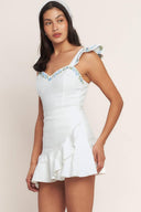 
A solid woven skort romper featuring sweetheart neckline, short flutter sleeve ruffle hem, embroidered detail and back zipper closure

Details:

Self : 97% Cotton 3% Spandex

Size &amp; Fit

- Model is 5`8" And Wearing Size Small
- Measurements Taken From Size Small
- Approx. Length: 33" Flying Tomato