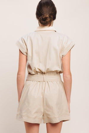 A solid woven romper featuring collar, short sleeve, button down, self belt, side and front pockets, and elastic back

Details:

Self: 97% Cotton 3% Spandex

Size & Fit

-Model is 5`8" And Wearing Size Small
-Measurements Taken From Size Small
-Approx. Length: 34"