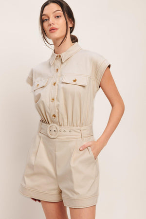 A solid woven romper featuring collar, short sleeve, button down, self belt, side and front pockets, and elastic back

Details:

Self: 97% Cotton 3% Spandex

Size & Fit

-Model is 5`8" And Wearing Size Small
-Measurements Taken From Size Small
-Approx. Length: 34"