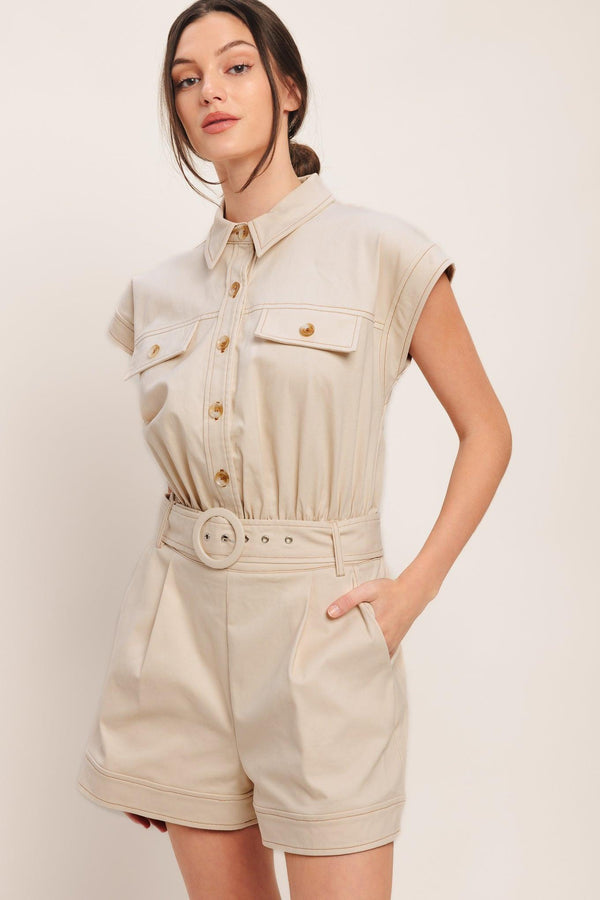 A solid woven romper featuring collar, short sleeve, button down, self belt, side and front pockets, and elastic back

Details:

Self: 97% Cotton 3% Spandex

Size & Fit

-Model is 5`8" And Wearing Size Small
-Measurements Taken From Size Small
-Approx. Length: 34"