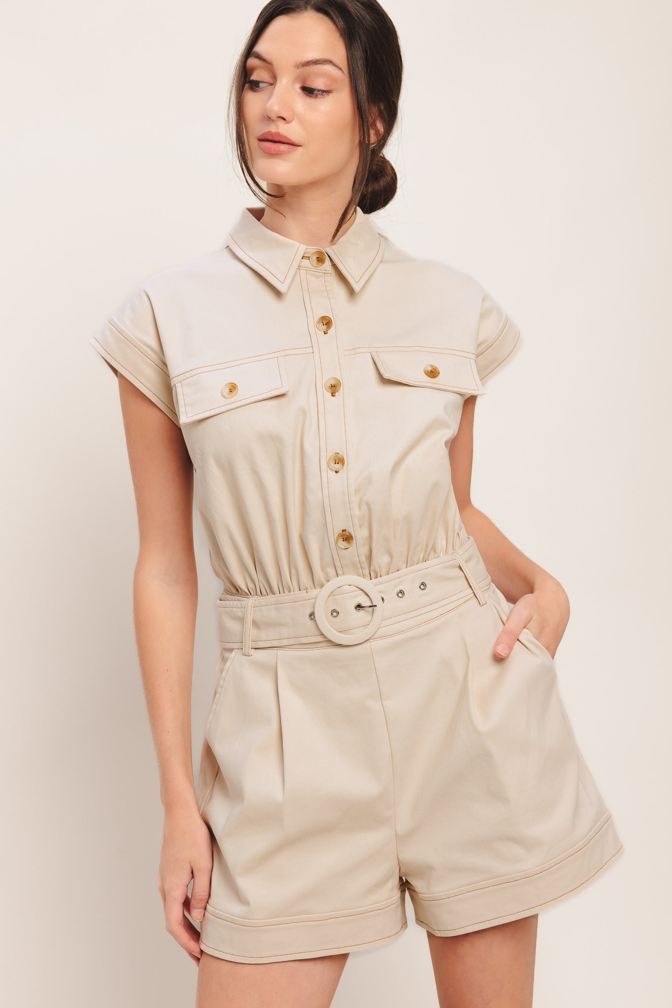 A solid woven romper featuring collar, short sleeve, button down, self belt, side and front pockets, and elastic back

Details:

Self: 97% Cotton 3% Spandex

Size & Fit

-Model is 5`8" And Wearing Size Small
-Measurements Taken From Size Small
-Approx. Length: 34"