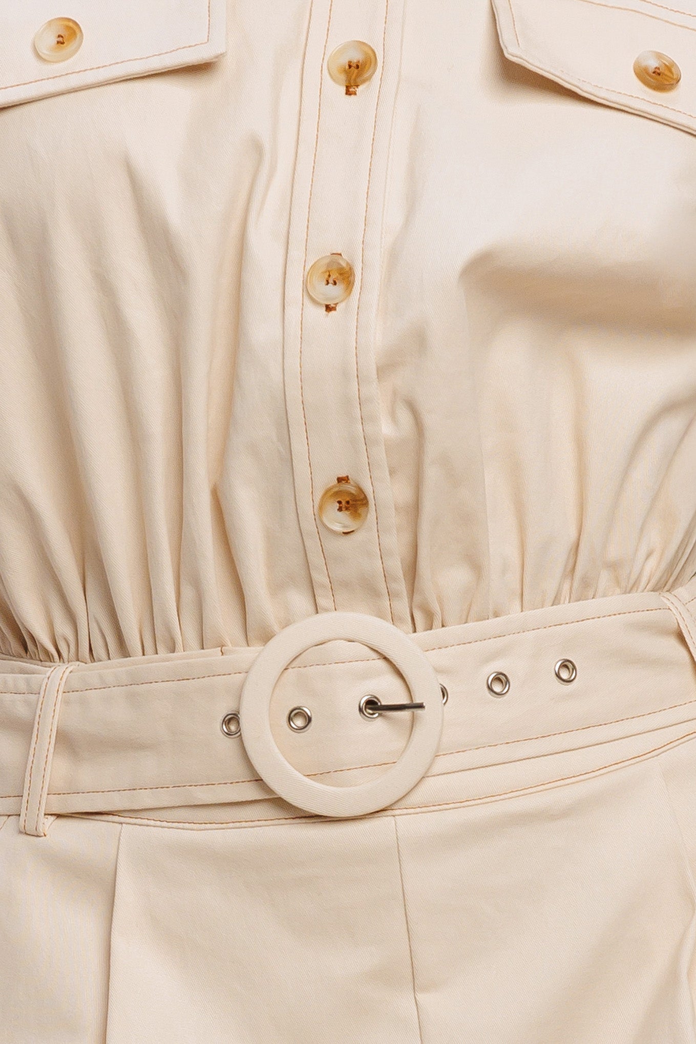 A solid woven romper featuring collar, short sleeve, button down, self belt, side and front pockets, and elastic back

Details:

Self: 97% Cotton 3% Spandex

Size & Fit

-Model is 5`8" And Wearing Size Small
-Measurements Taken From Size Small
-Approx. Length: 34"