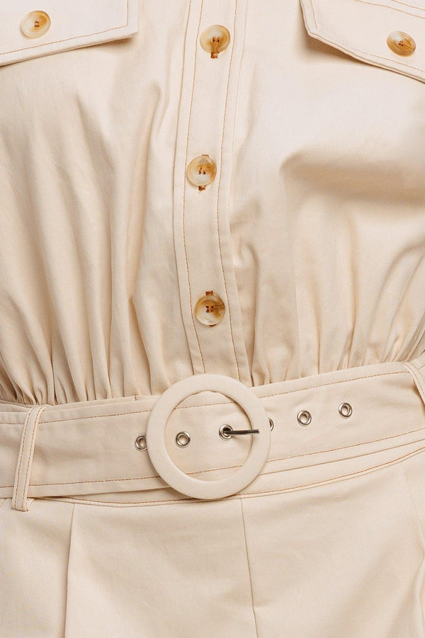 A solid woven romper featuring collar, short sleeve, button down, self belt, side and front pockets, and elastic back

Details:

Self: 97% Cotton 3% Spandex

Size & Fit

-Model is 5`8" And Wearing Size Small
-Measurements Taken From Size Small
-Approx. Length: 34"