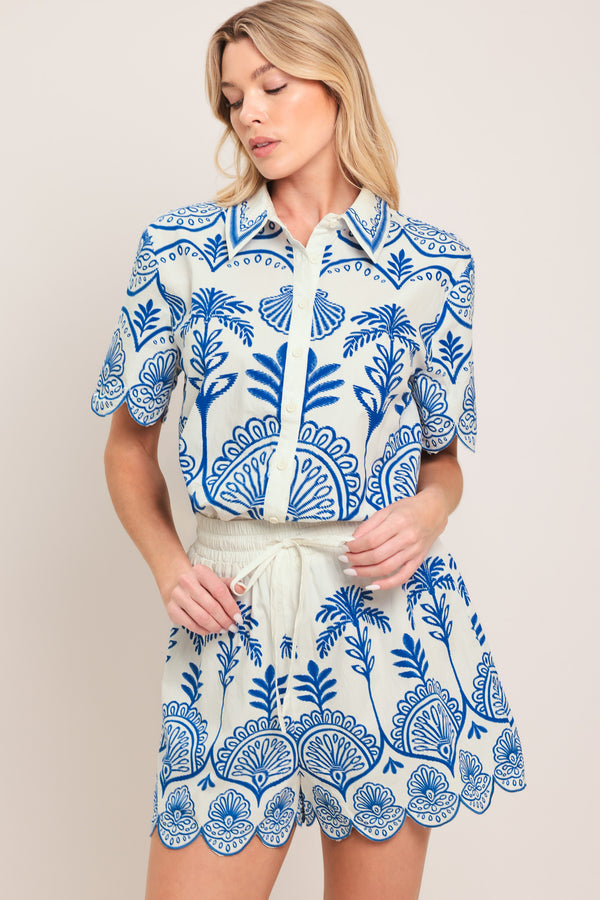 Woman wearing whit and blue shorts with elastic waist with tie and scallop edge | Flying Tomato