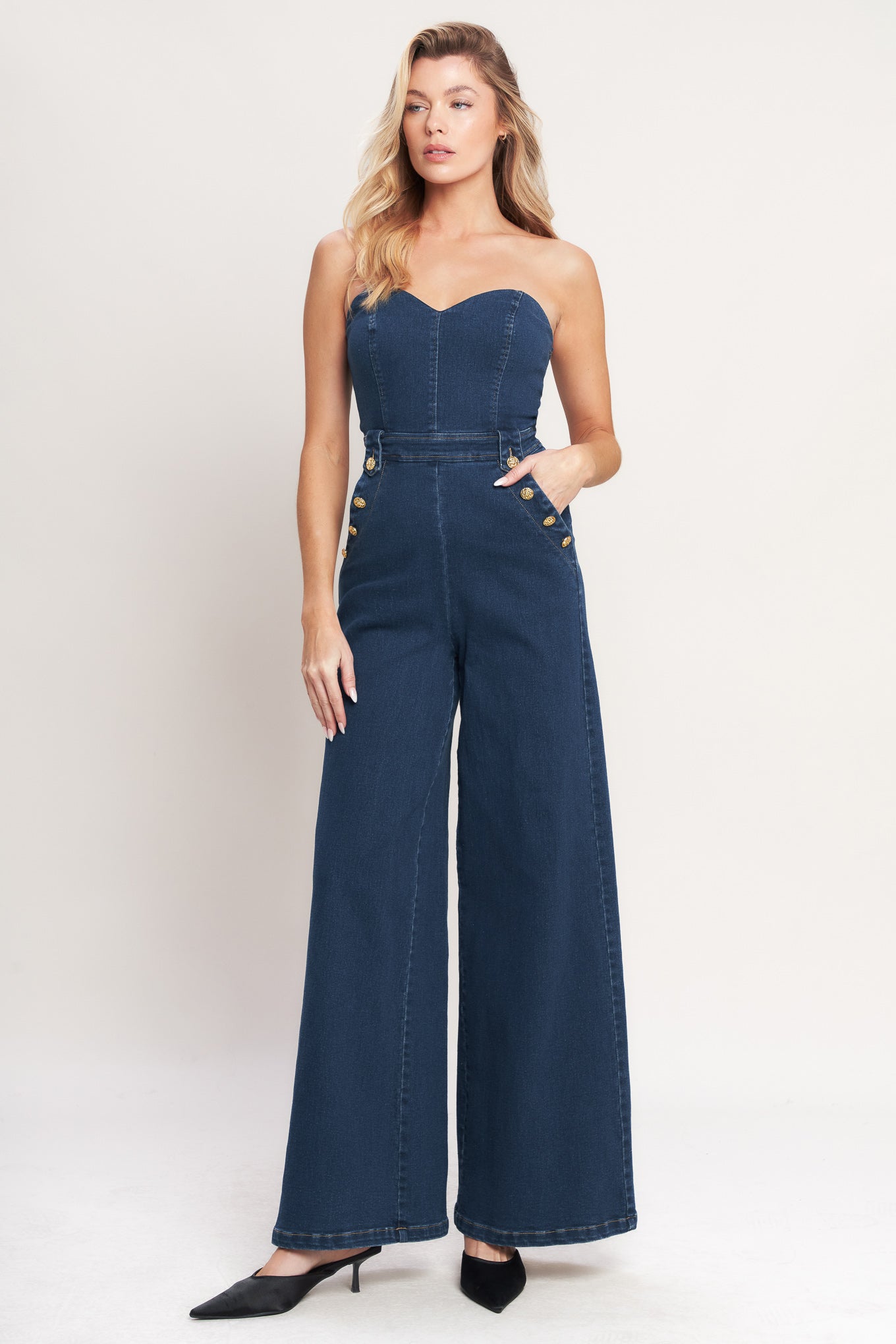 A washed denim jumpsuit featuring strapless, sweetheart neckline, side pockets with buttons, wide leg and back zipper closure

Details:

Self: 75% Cotton 23% Polyester 2% Spandex

Size & Fit

- Model is 5`8" And Wearing Size Small
- Measurements Taken From Size Small
- Approx. Length: 54"