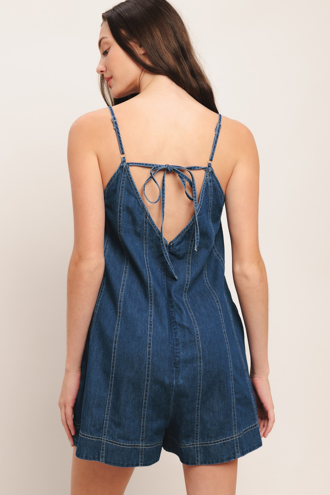 A lightweight denim romper with back tie and zipper closure

Details:

Self: 100% Cotton

Size & Fit

-Model is 5`8" And Wearing Size Small
-Measurements Taken From Size Small
-Approx. Length: 32"