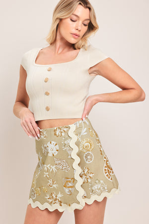 Woman wearing a skort with decorative pattern and scalloped edge skort | Flying Tomato