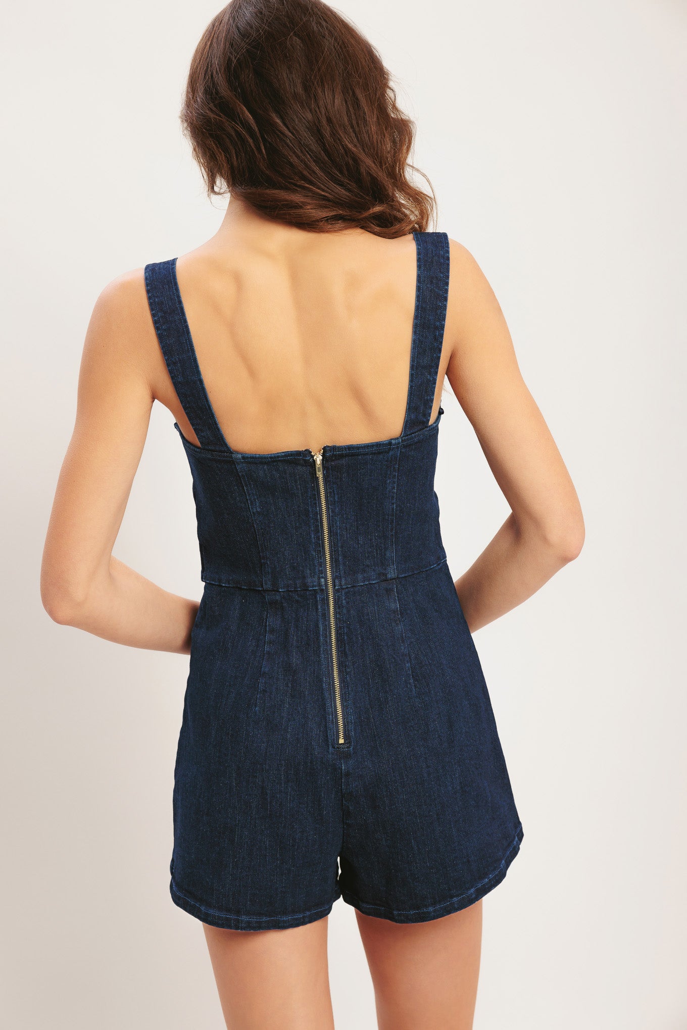 
A solid denim romper featuring straight neckline, straps, front button detail and back zipper closure

Details:

Self : 98% Cotton 2% Spandex

Size &amp; Fit

- Model is 5`8" And Wearing Size Small
- Measurements Taken From Size Small
- Approx. Length: 30"