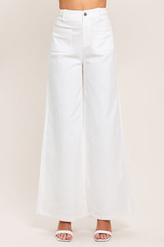 Woman wearing white wide-leg pants with front closure and braided detail waistband | Flying Tomato