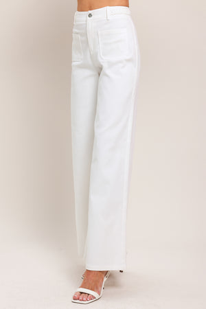 Woman wearing white wide-leg pants with front closure and braided detail waistband | Flying Tomato