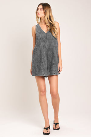 Woman wearing a lightweight denim romper with V neckline and zipper back closure | Flying Tomato