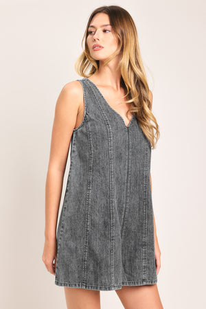 Woman wearing a lightweight denim romper with V neckline and zipper back closure | Flying Tomato