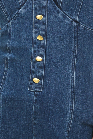 Close-up of a blue denim jumpsuit with gold buttons | Flying Tomato