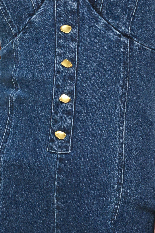 Close-up of a blue denim jumpsuit with gold buttons | Flying Tomato