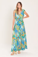 Woman wearing a blue multicolored patterned woven jumpsuit featuring V neckline, shoulder ties, smocked waistband and wide leg | Flying Tomato
