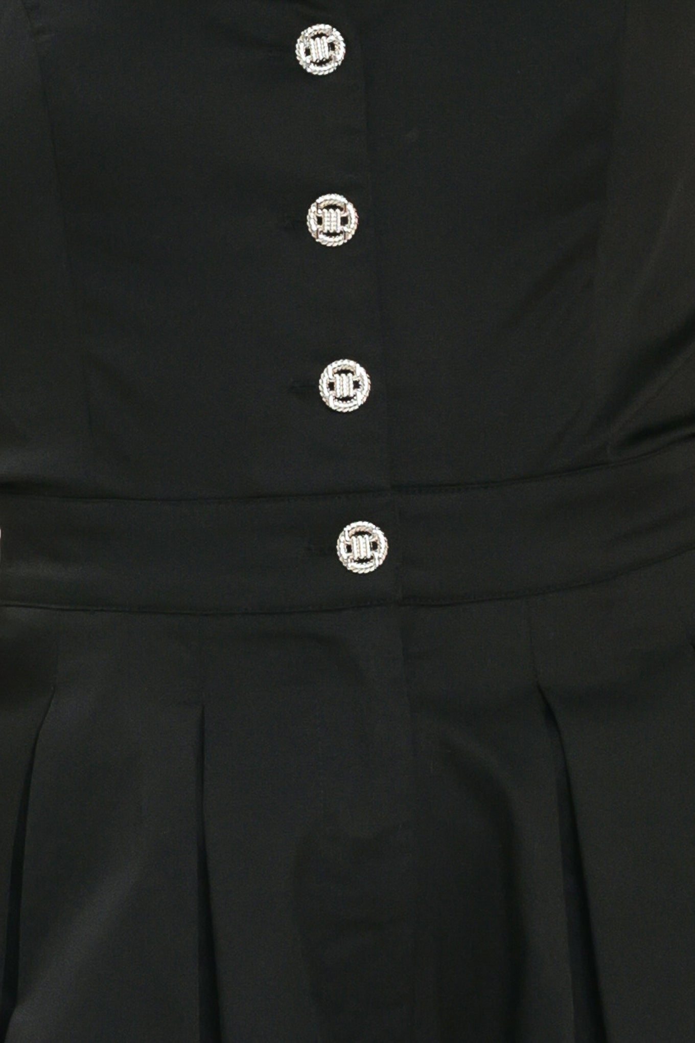 Woman wearing a black wide leg jumpsuit with buttons | Flying Tomato