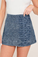 Woman wearing a blue patterned denim skort with side zipper closure | Flying Tomato