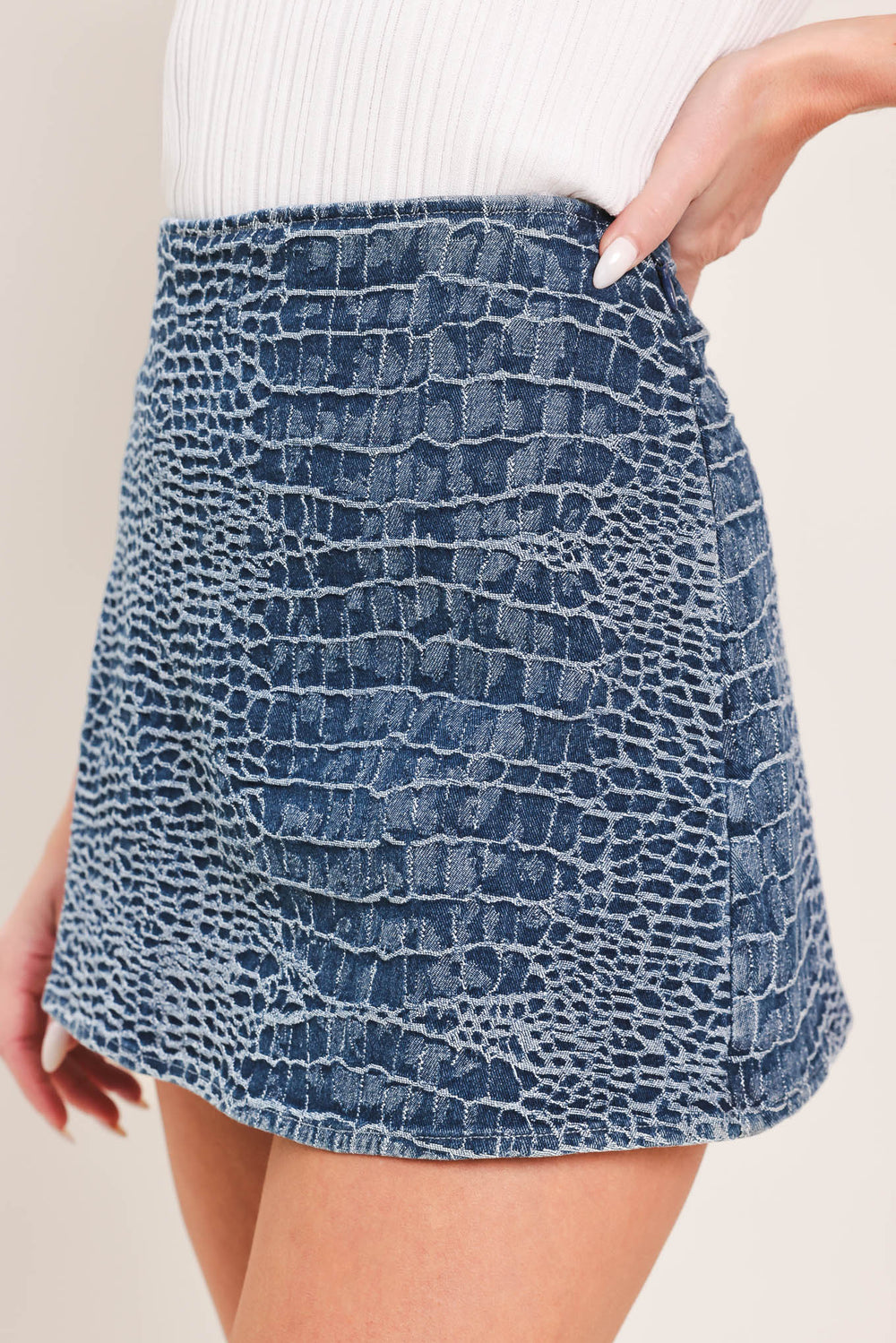 Woman wearing a blue patterned denim skort with side zipper closure | Flying Tomato