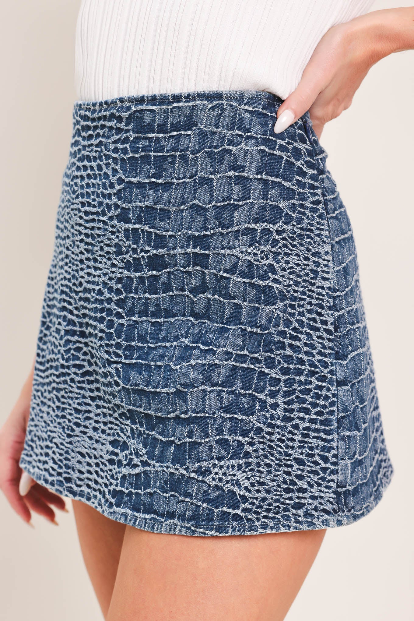 Woman wearing a blue patterned denim skort with side zipper closure | Flying Tomato