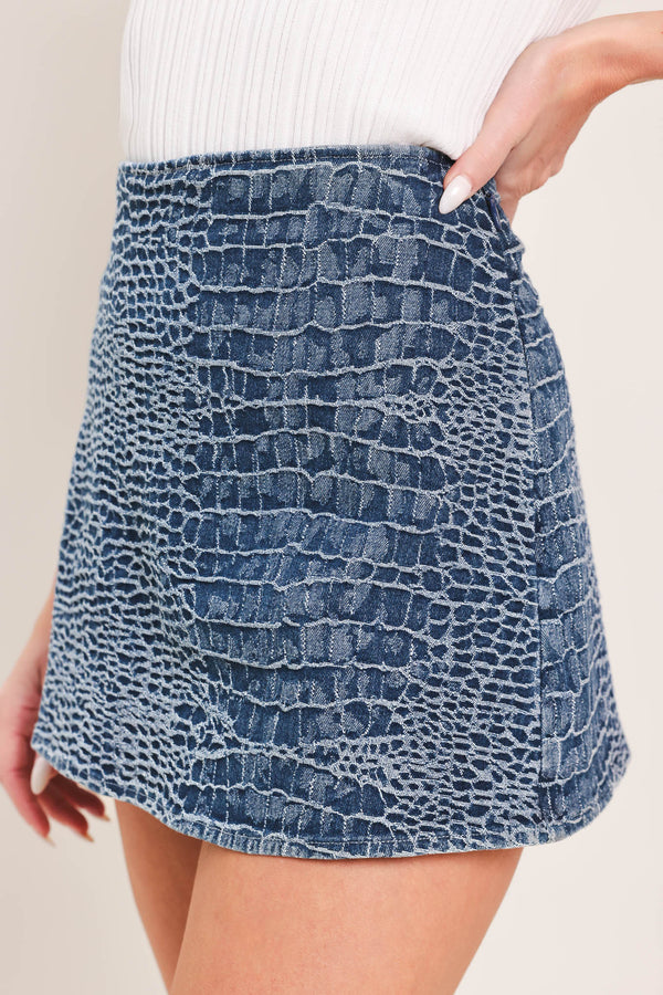 Woman wearing a blue patterned denim skort with side zipper closure | Flying Tomato