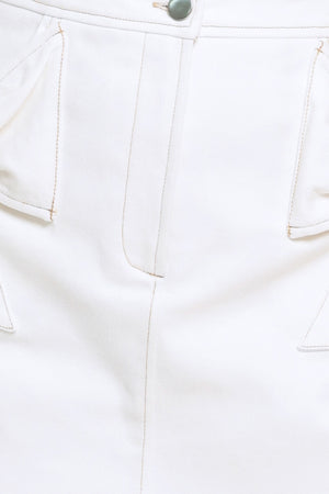 Close-up of a white skort with a button detail | Flying Tomato